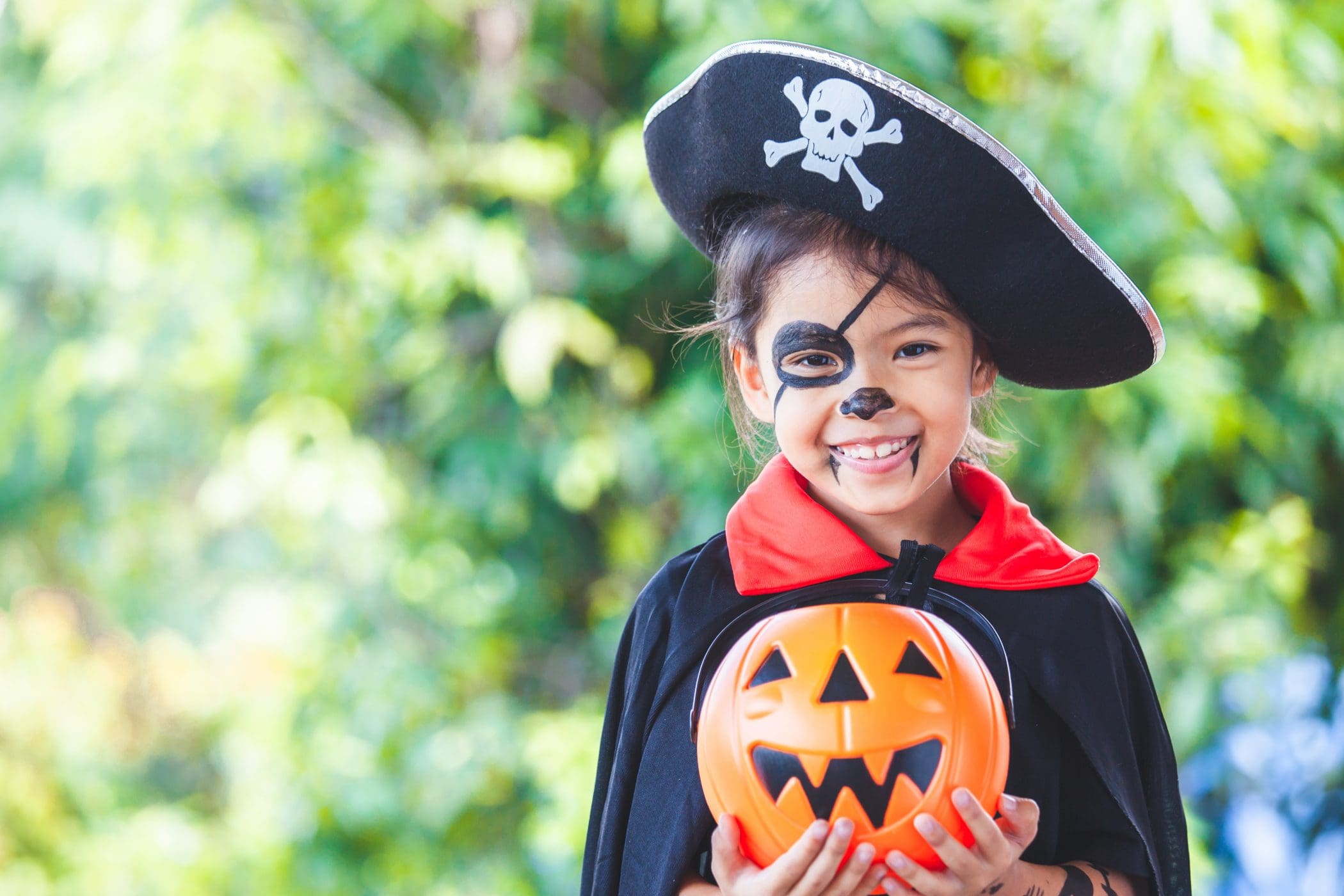 Cute asian child girl wearing halloween costumes and makeup havi
